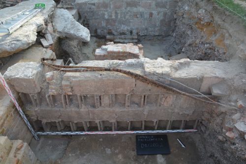 walls made of concrete blocks uncovered in an archaeological trench