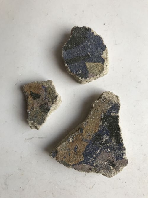 three fragments of painted plaster