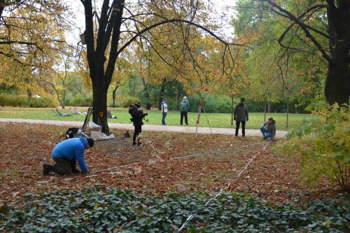 a group of people conducting scientific research in a park