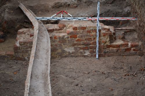 an archaeological trench and measuring equipment