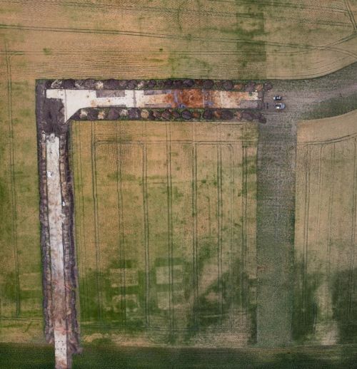 an aerial view of an excavation trench in a field