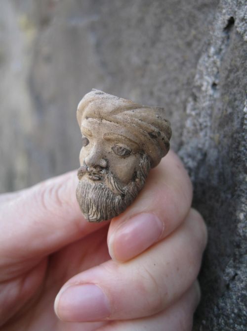 a small pipe with a man's head