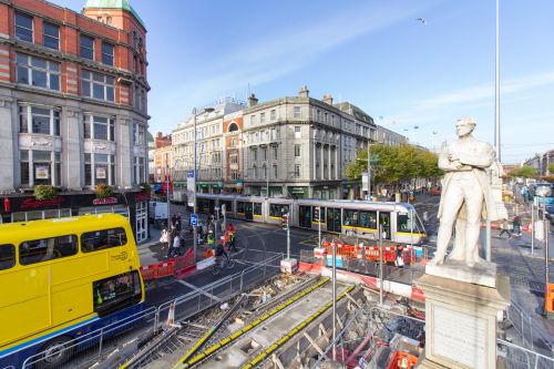 O'Brien National Monument on O'Connell Street, showing LCC construction works and an inbound Luas Red Line tram