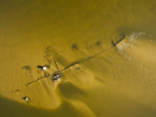 Aerial view of a shipwreck in shallow water