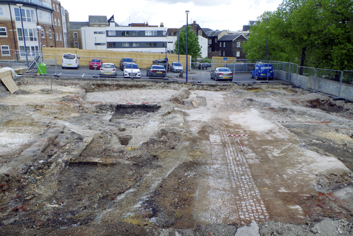 excavated trenches and brickwork infront of car park