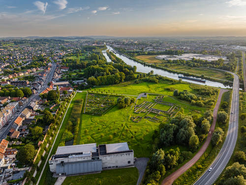 The Ename Heritage Site, with the ruins of the Benedictine abbey, the River Scheldt, and the contemporary building housing the repository.