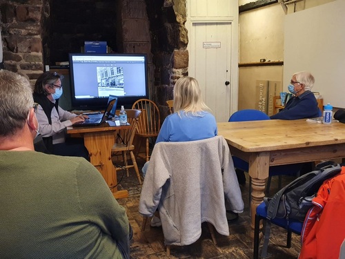 A group of people in a room with a computer